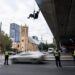 A woman abseils over a bridge in Adelaide during an Extinction Rebellion protest on 18 May.