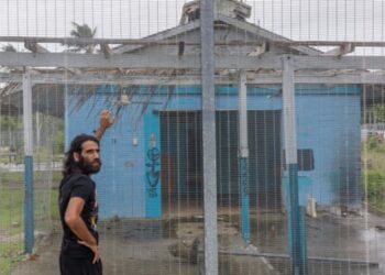 Behrouz Boochani on Manus in 2018, outside the naval base where he and other refugees were detained for his first three years on the island