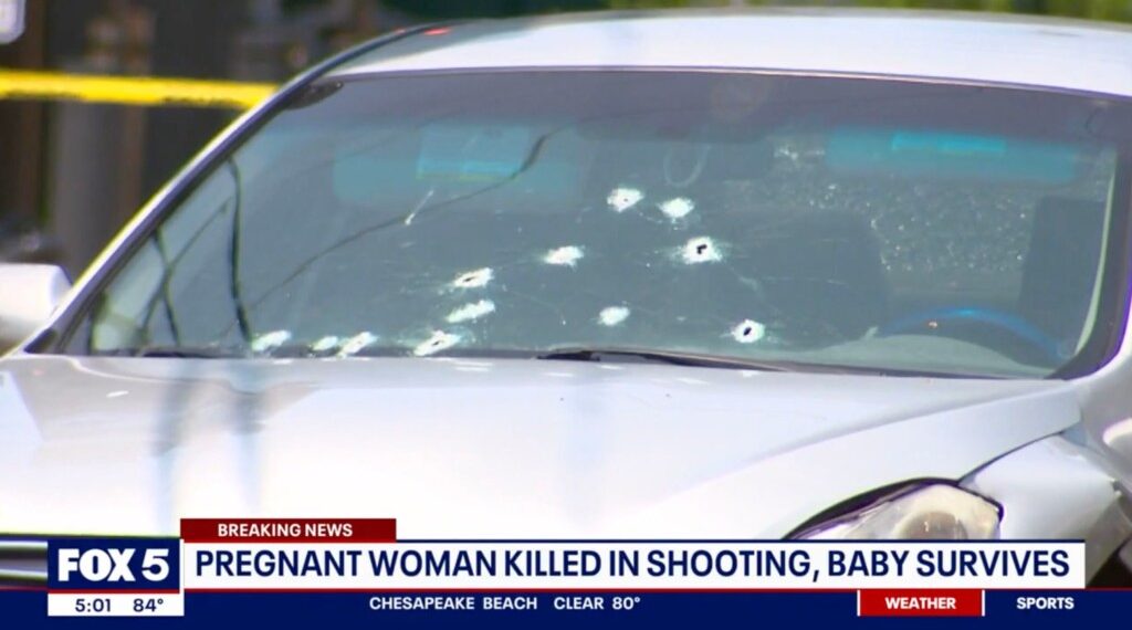 Car with bullet holes in windshield.