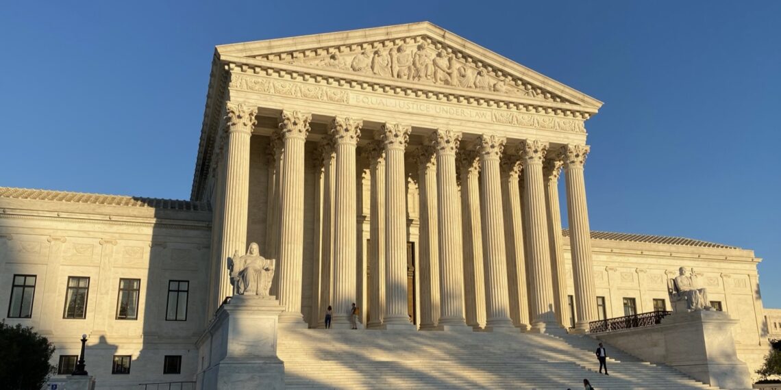 front view of supreme court building with plaza engulfed in shadows