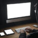 hooded person on computer