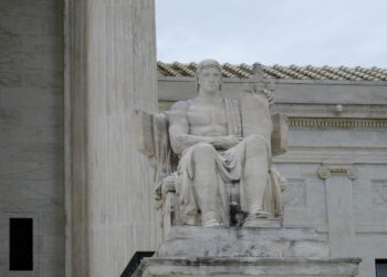 The statute of a seated man outside the Supreme Court
