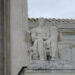 The statute of a seated man outside the Supreme Court