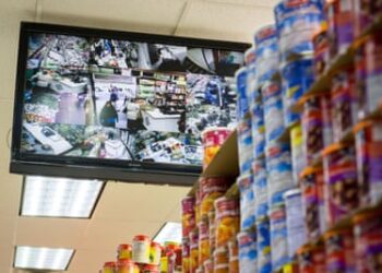 A monitor shows the video feeds of security cameras in a supermarket.
