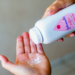 Baby powder from Johnson and Johnson being shaken into a person's hand