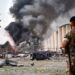 A soldier stands guard as a helicopter extinguishes a fire at the scene of an explosion at Beirut’s port in 2020