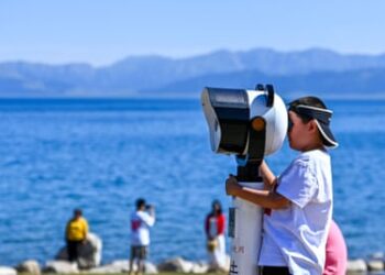 Tourists visit Sayram Lake in Xinjiang, north-western China.