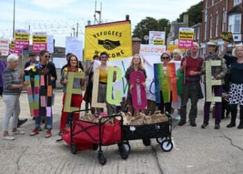 Protesters deliver welcome packs to the front gate of Portland port for the first asylum seekers to arrive at the Bibby Stoockholm.
