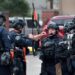 The St. Louis police SWAT team gathers in front of the city jail in downtown St. Louis, known as the City Justice Center, after a guard was reportedly taken hostage on Tuesday, Aug. 22, 2023.