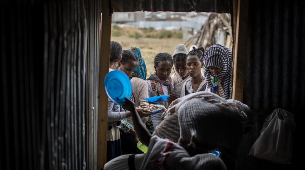 Tigrayans stand in line to receive food donated by local residents at a reception center for the internally displaced in Mekele, in the Tigray region of northern Ethiopia, on May 9, 2021. Credit: AP.