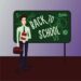Back to School. Male teacher in a classroom standing near chalk board.