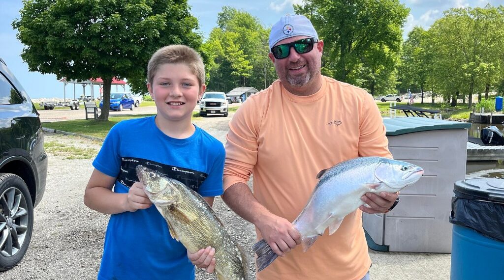 House explosion victims Casey Clontz, 38, and his son, Keegan, 12, holding fish