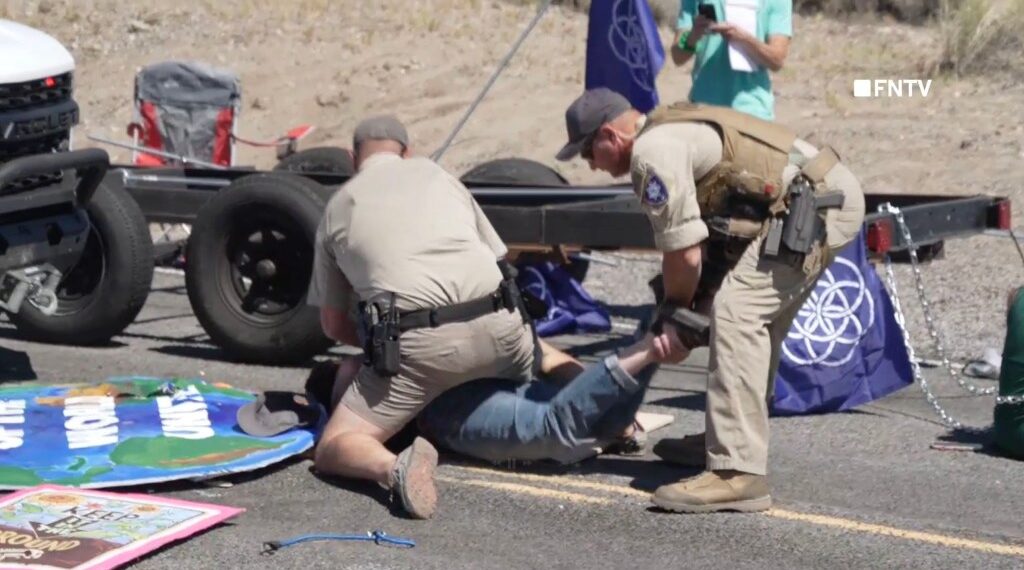 Two rangers were seen in video from the protest handcuffing a protesters' ankles together.
