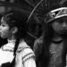 An image of two Native American children in their cultural garbs.