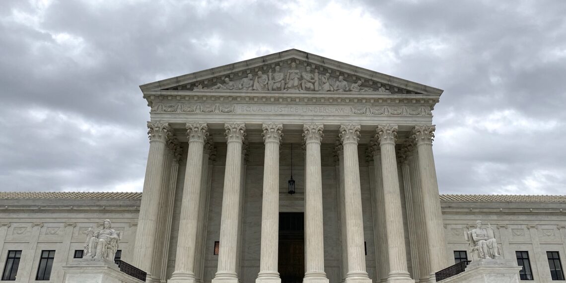 front view of supreme court with solitary person walking on plaza in front