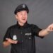 Frustrated Caucasian man wearing police uniform costume in studio