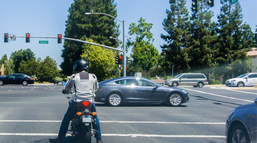 Motorcycle rider on at a stoplight.