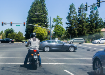 Motorcycle rider on at a stoplight.