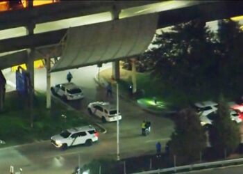 The two officers, a 50-year-old and a 60-year-old, had just stepped out of their vehicle inside the garage when they "observed a few individuals breaking into another vehicle."