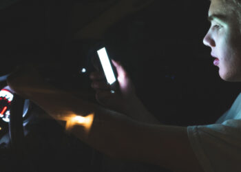 Kid driving while on cellphone