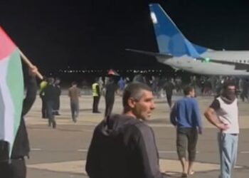 A from video footage shows protesters with a Palestinian flag invading the runway of Makhachkala airport