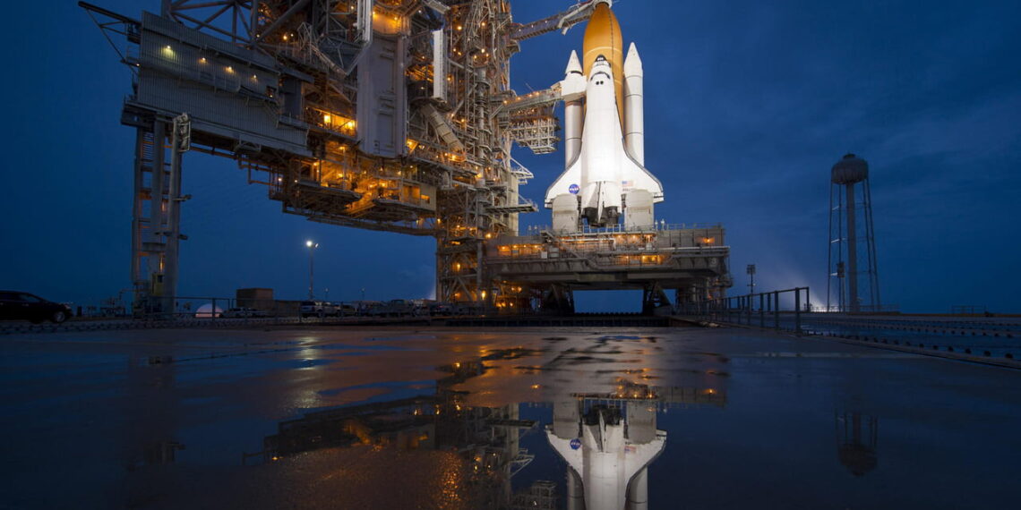 Photo of space shuttle near body of water.