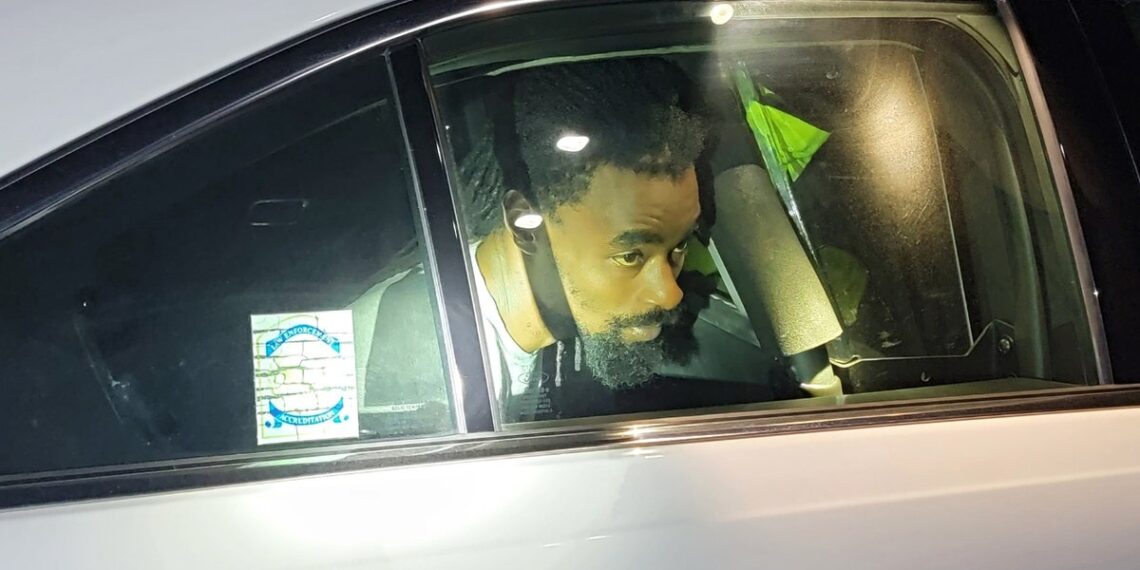 Shaquille Taylor in a police vehicle