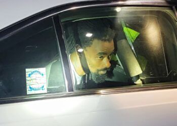 Shaquille Taylor in a police vehicle