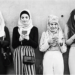 Four teen girls in hijabs paired with modern clothing are leaning against a wall, looking at their phones.Source: Yahoo Images
