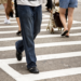A large group of pedestrians in a large crosswalk.