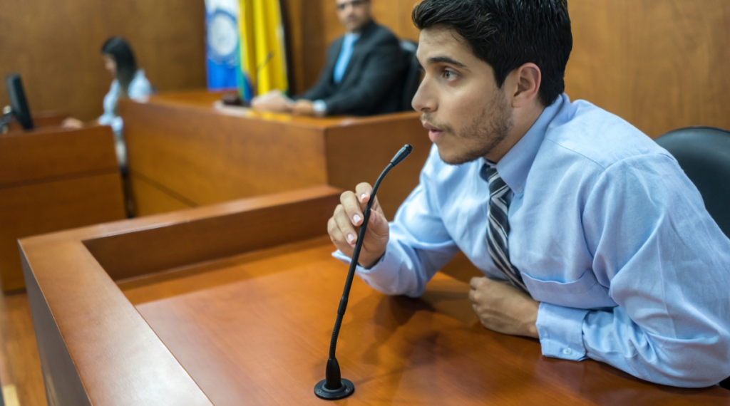 A well dressed business man testifying in a court of law.