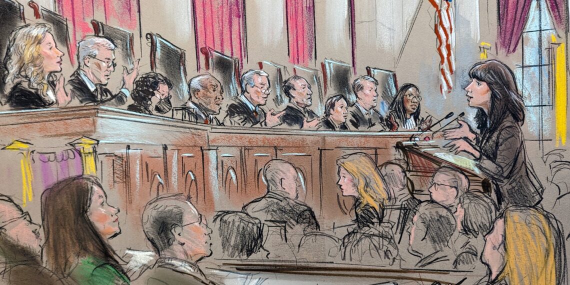 Woman speaking to all nine justices in front of a crowd of listeners and journalists