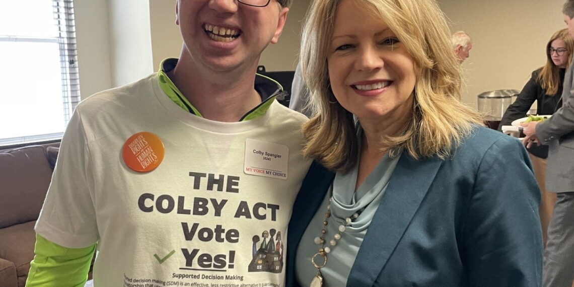 Colby wearing a shirt that says "The Colby Act, vote yes!" next to Representative Cynthia Almond of Tuscaloosa.