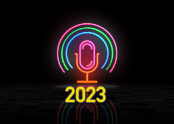 A glowing neon podcast mic sign with the year 2023 superimposed on in