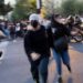 Blurred photo of two women running towards the camera as other people can be seen scattering