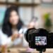 Young female blogger on camera screen