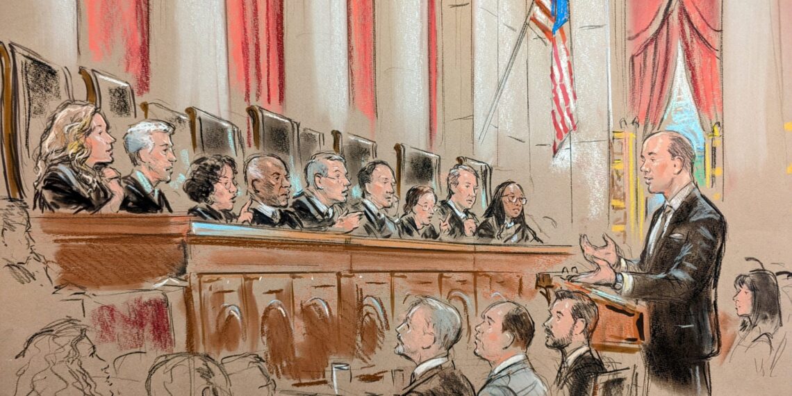 Man speaking before full bench of justices