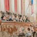 Man speaking before full bench of justices
