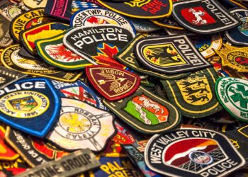 Young law enforcement enthusiast collects patches from agencies across the globe