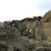 Image 1. Afghan Man standing in the rumble caused by an earthquake. Source: Flickr