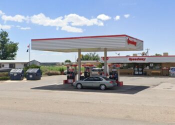 Speedway gas station, gas prices sign, car parked by gas pump, car parked by store