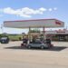 Speedway gas station, gas prices sign, car parked by gas pump, car parked by store