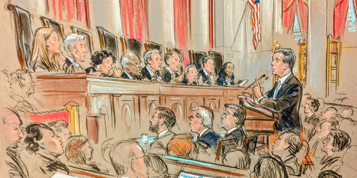 In a full courtroom, the audience looks on as a lawyer stands and discusses his case with all nine justices on the bench.