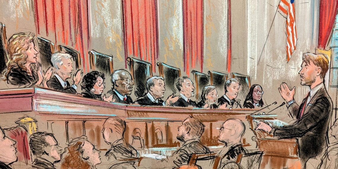 All nine justices speaking on the bench to lawyer at lectern with group looking on.
