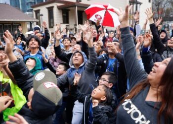 San Jose Earthquakes fans reach for a jersey thrown in the air at the San Jose Earthquakes' 50th anniversary block party at San Pedro Square Market in downtown San Jose, Calif., on Sunday, Feb. 18, 2024. (Nhat V. Meyer/Bay Area News Group)