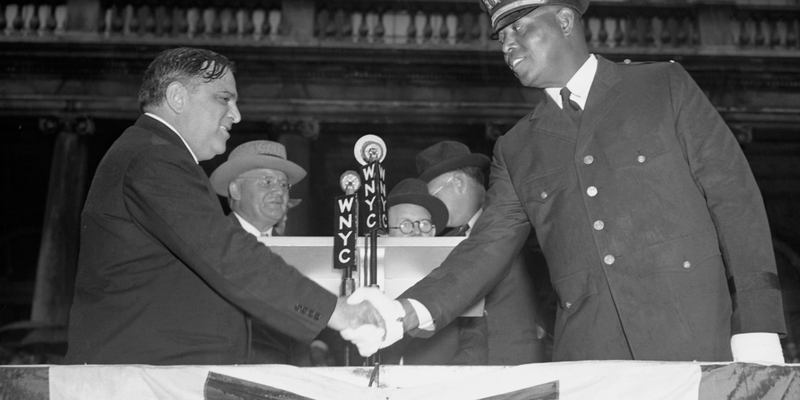 New York mayor shakes hand with first black police officer