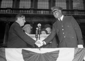 New York mayor shakes hand with first black police officer