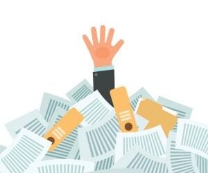 Overworked businessman under a lot of documents