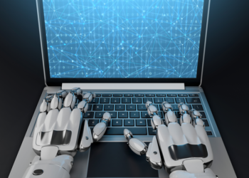 robot hands typing at a computer