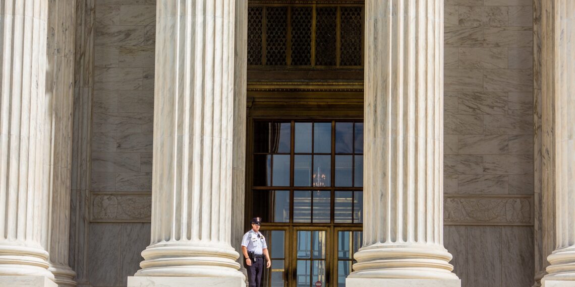 Guard standing on the Supreme Court steps.